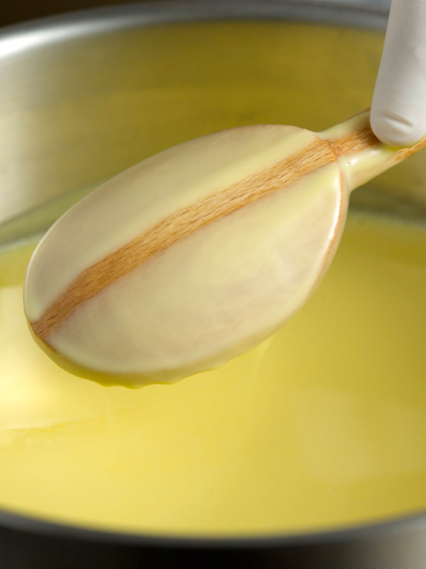 A sauce being tested for thickness on a wooden spoon