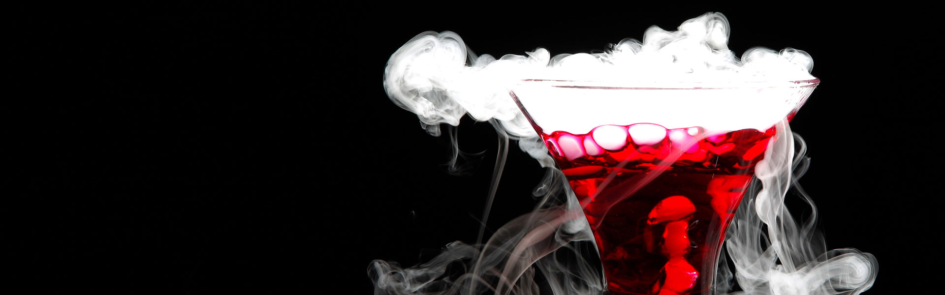 A CIA Halloween-themed dining event with a red cocktail surrounded by eerie white smoke.