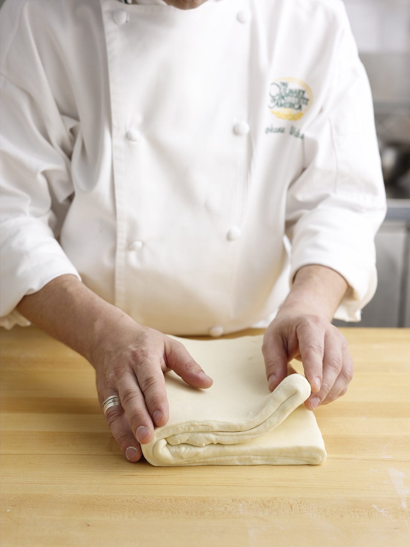 Folding the pastry dough using the four-fold, or book-fold method.