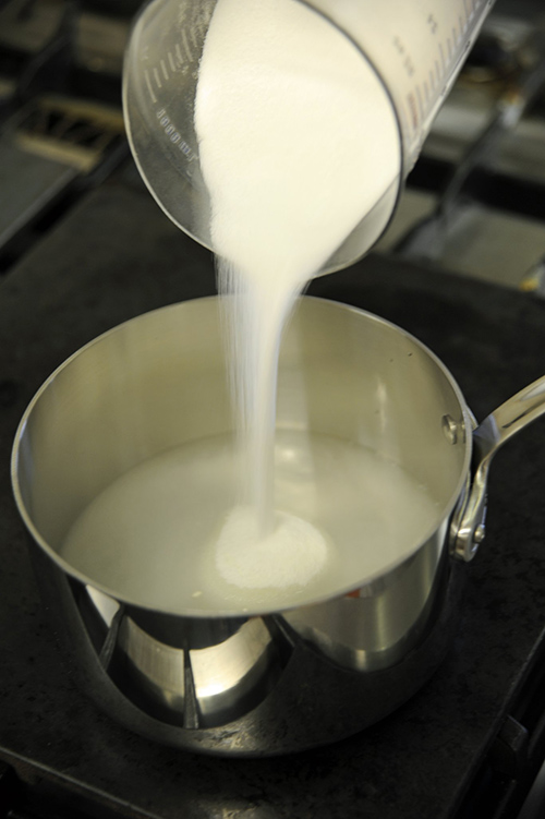 Combine the sugar and water in a saucepan and stir to moisten the sugar completely. Bring the mixture to a boil.