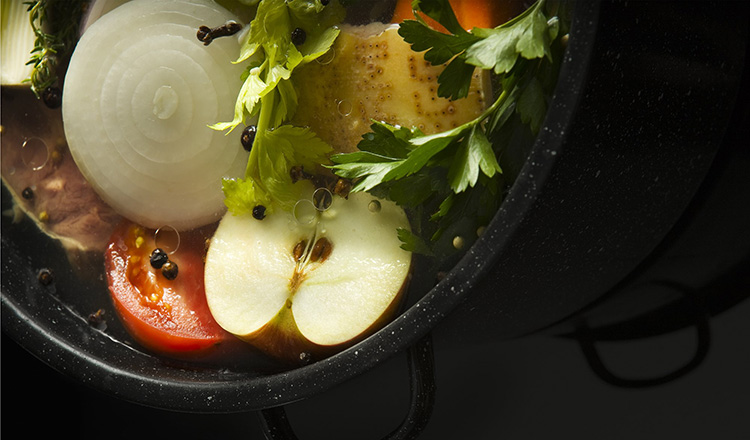 Raw ingredients and water inside a pot ready to start cooking for the preparation of Brodo di Carne.