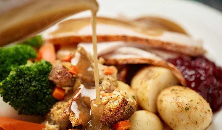 Turkey, stuffing, gravy, vegetables on a plate