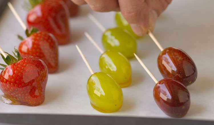 Candied fruit on toothpicks.