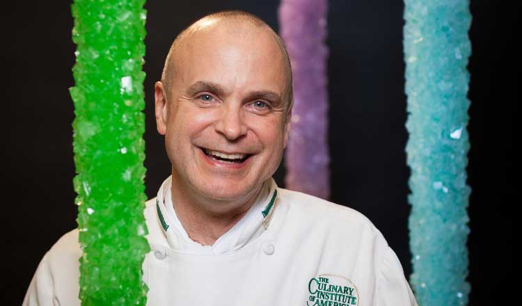 CIA Chef Peter Greweling with giant rock candy columns.