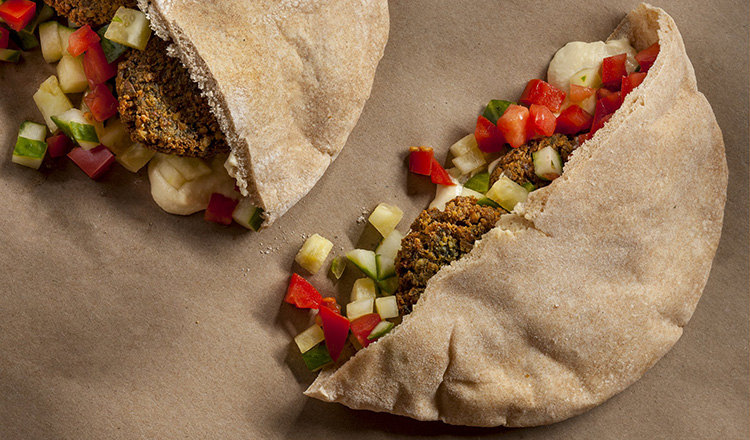 Pita stuffed with falafel, diced cucumber, diced tomato and hummus