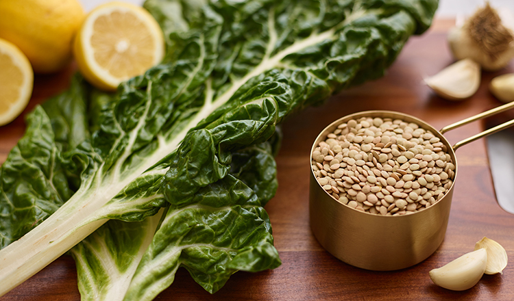 Green Lentils, Swiss Chard, and lemon on a cutting board