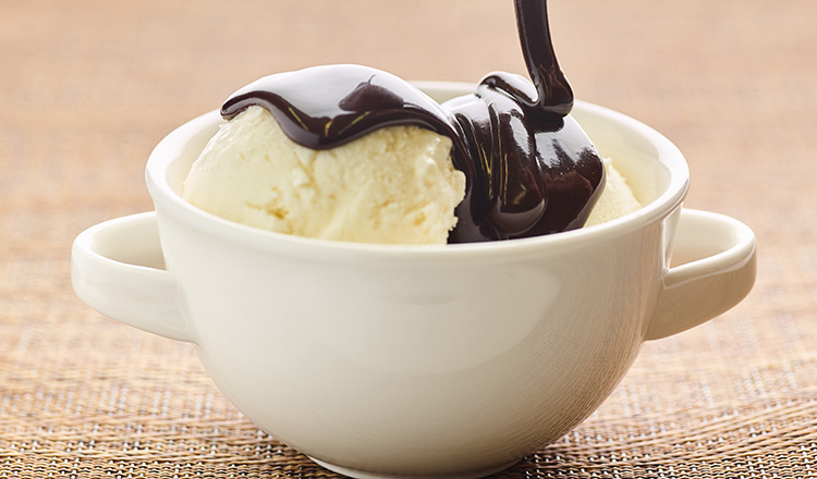 Hot fudge sauce over vanilla ice cream