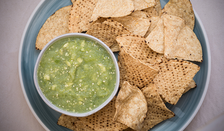 Raw tomatillo salsa with tortilla chips