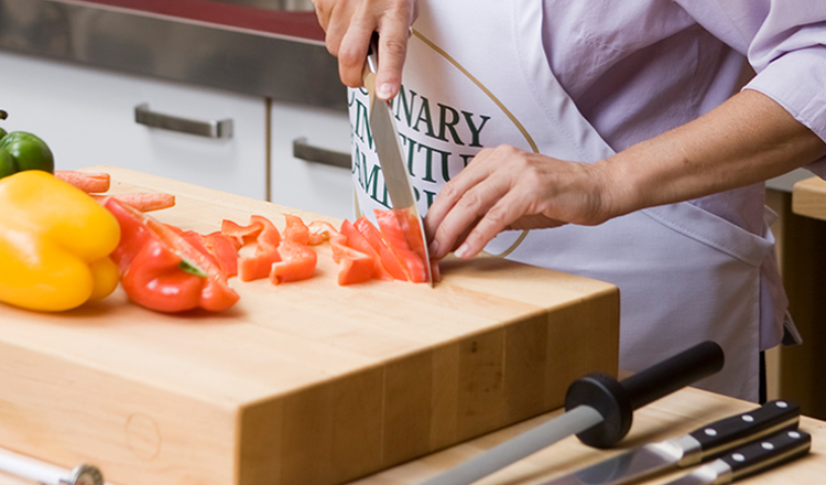 Chopping peppers with knives from The Culinary Institute of America tool kit.