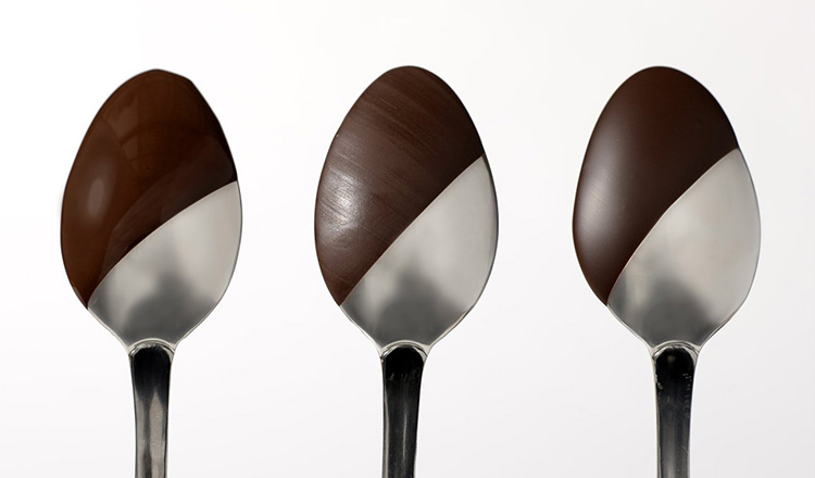 Spoons showing untempered, partially tempered, and properly tempered dark chocolate.