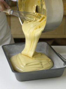 Pouring cooked sponge candy in baking pan