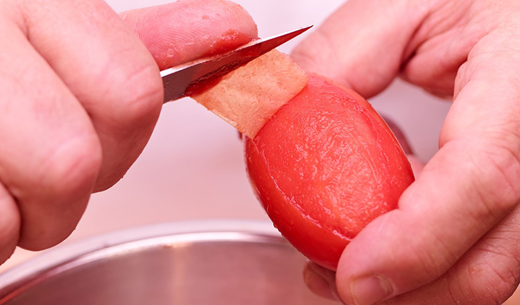 Blanching and peeling tomatoes.