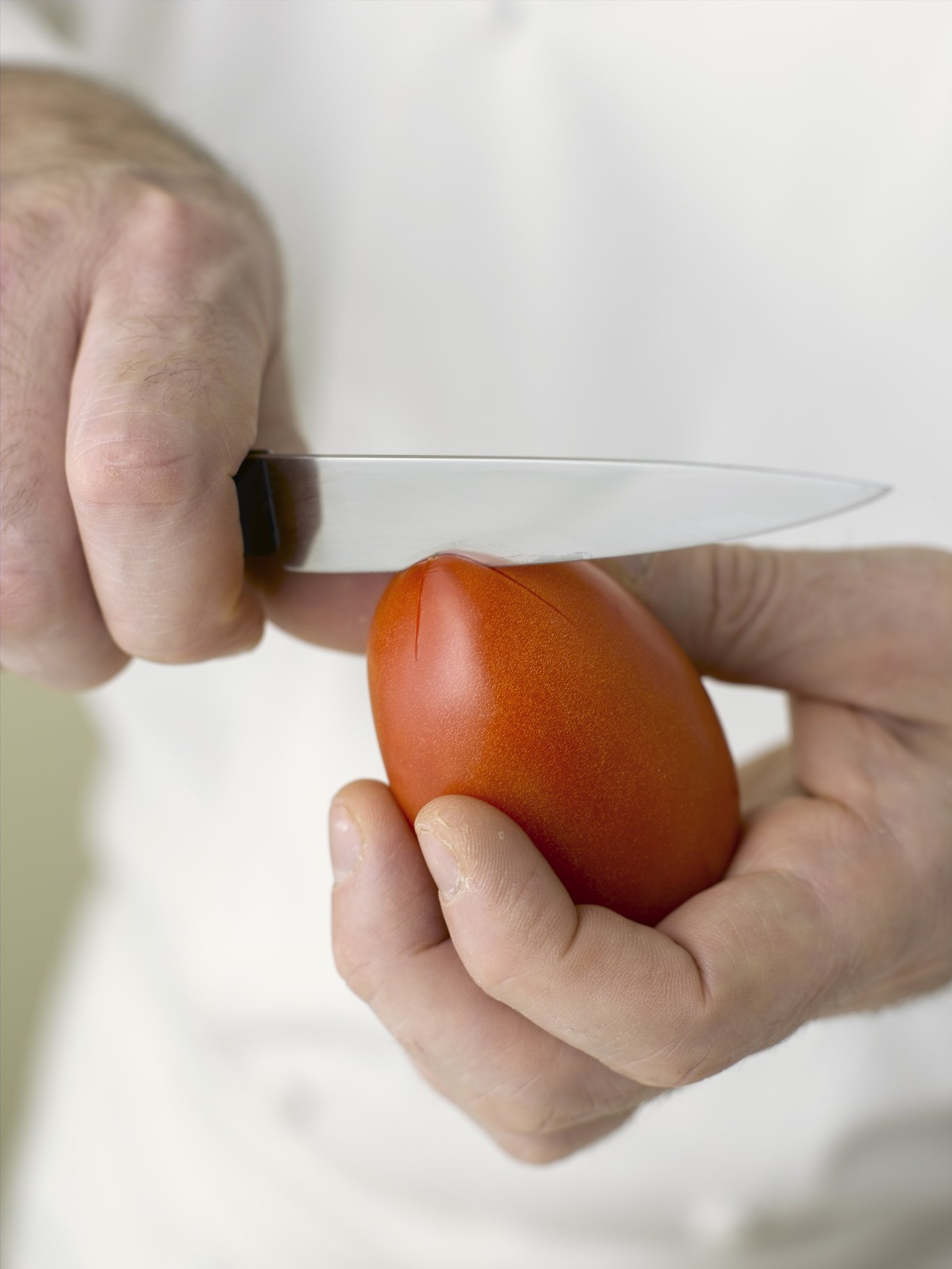 Cut an X into the bottom of the tomato.