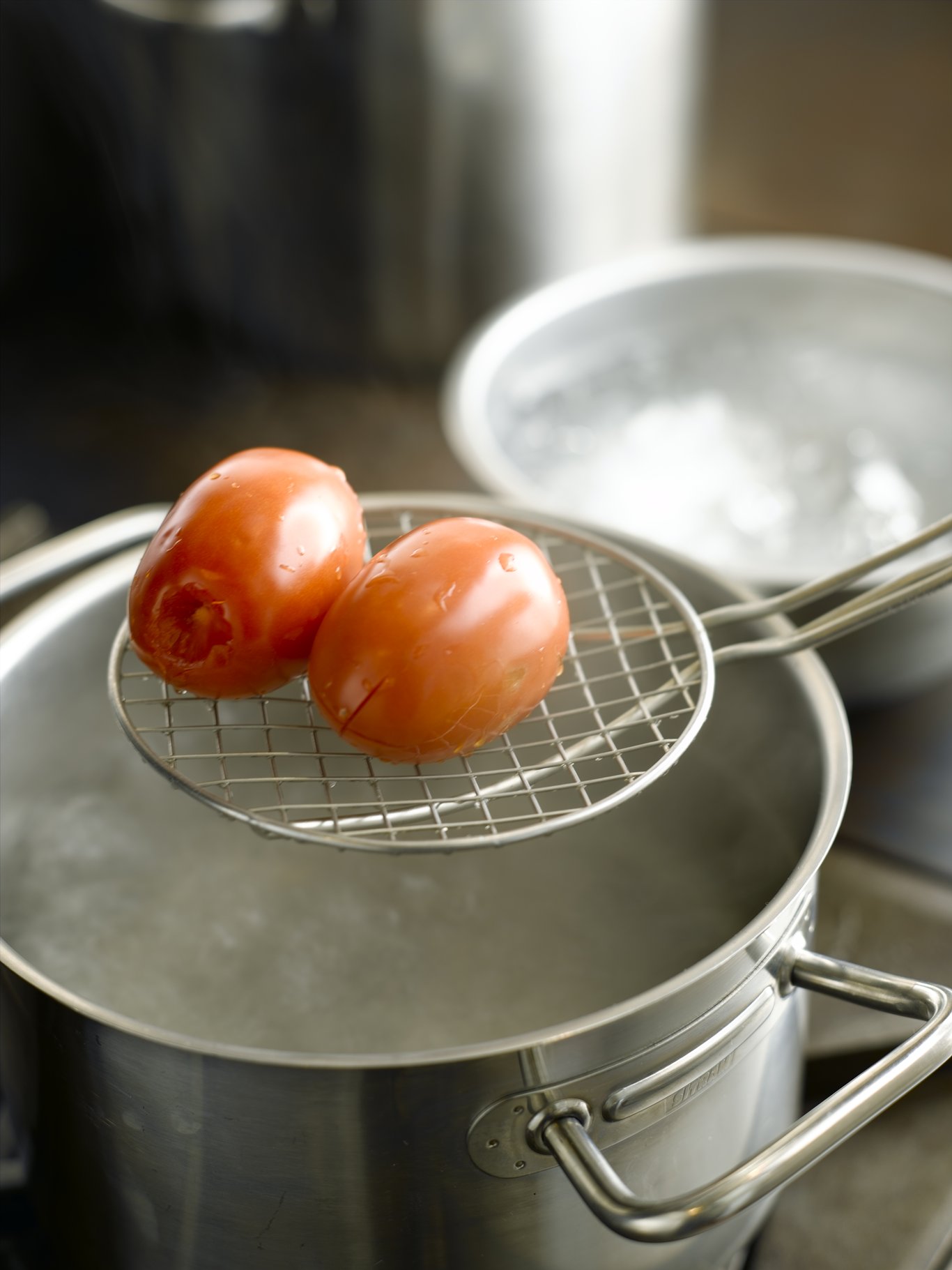 After leaving the tomatoes in boiling water for 10 to 15 seconds, remove with slotted spoon, skimmer, or spider.