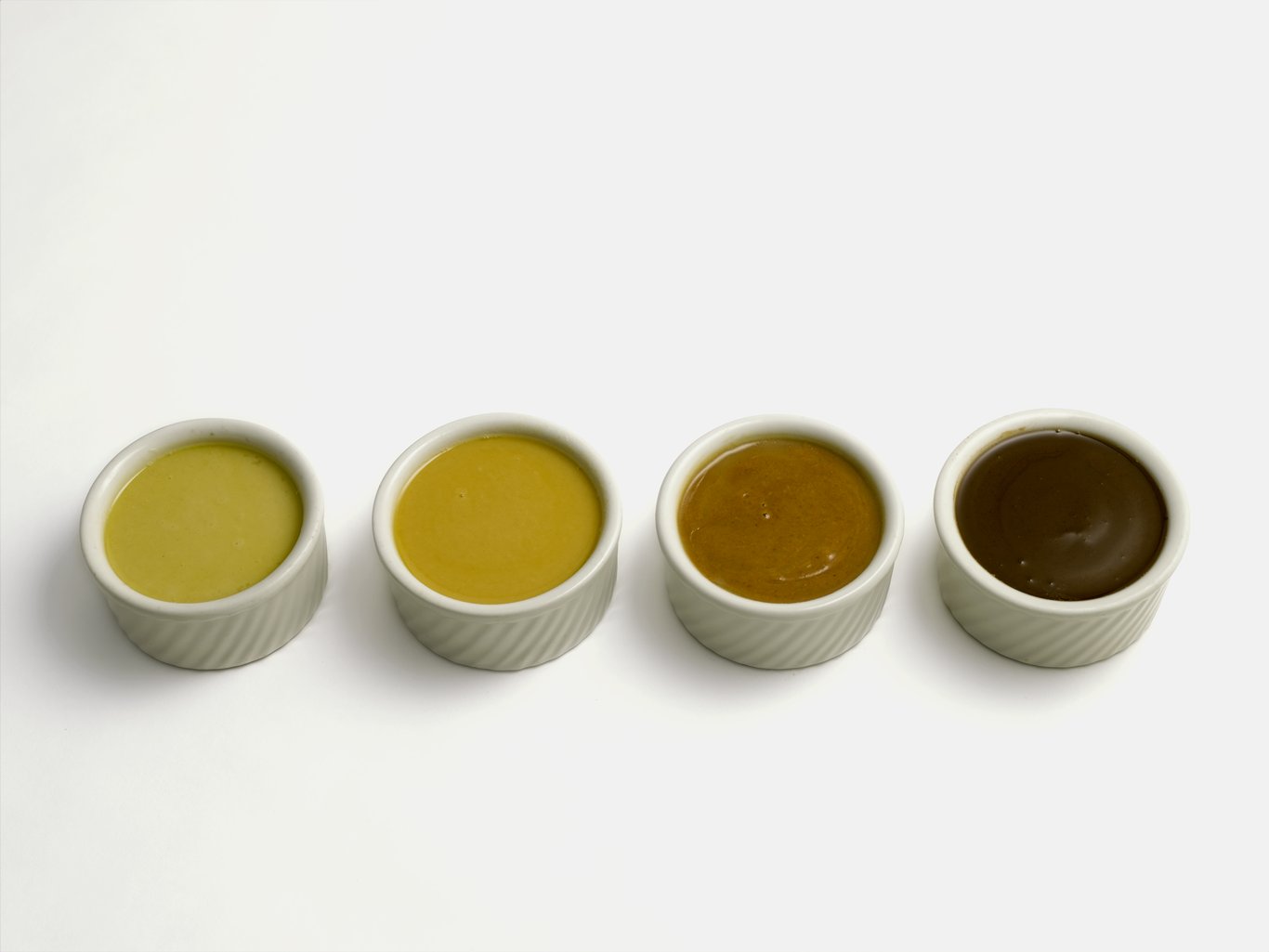 Roux (from left to right): white, blond, brown, dark.  Roux is an appareil containing equal parts of flour and fat (usually butter) used to thicken liquids.