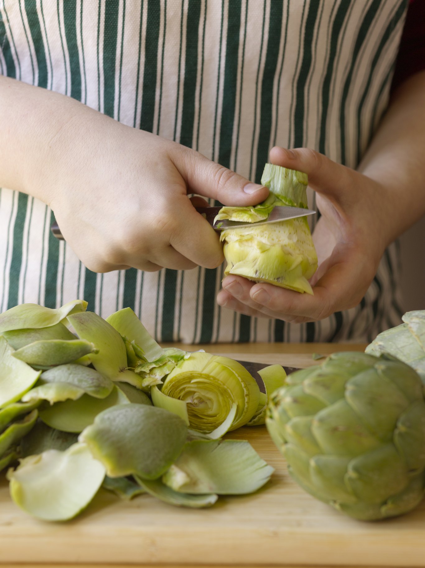 Trim away the tough outer leaves with a paring knife.