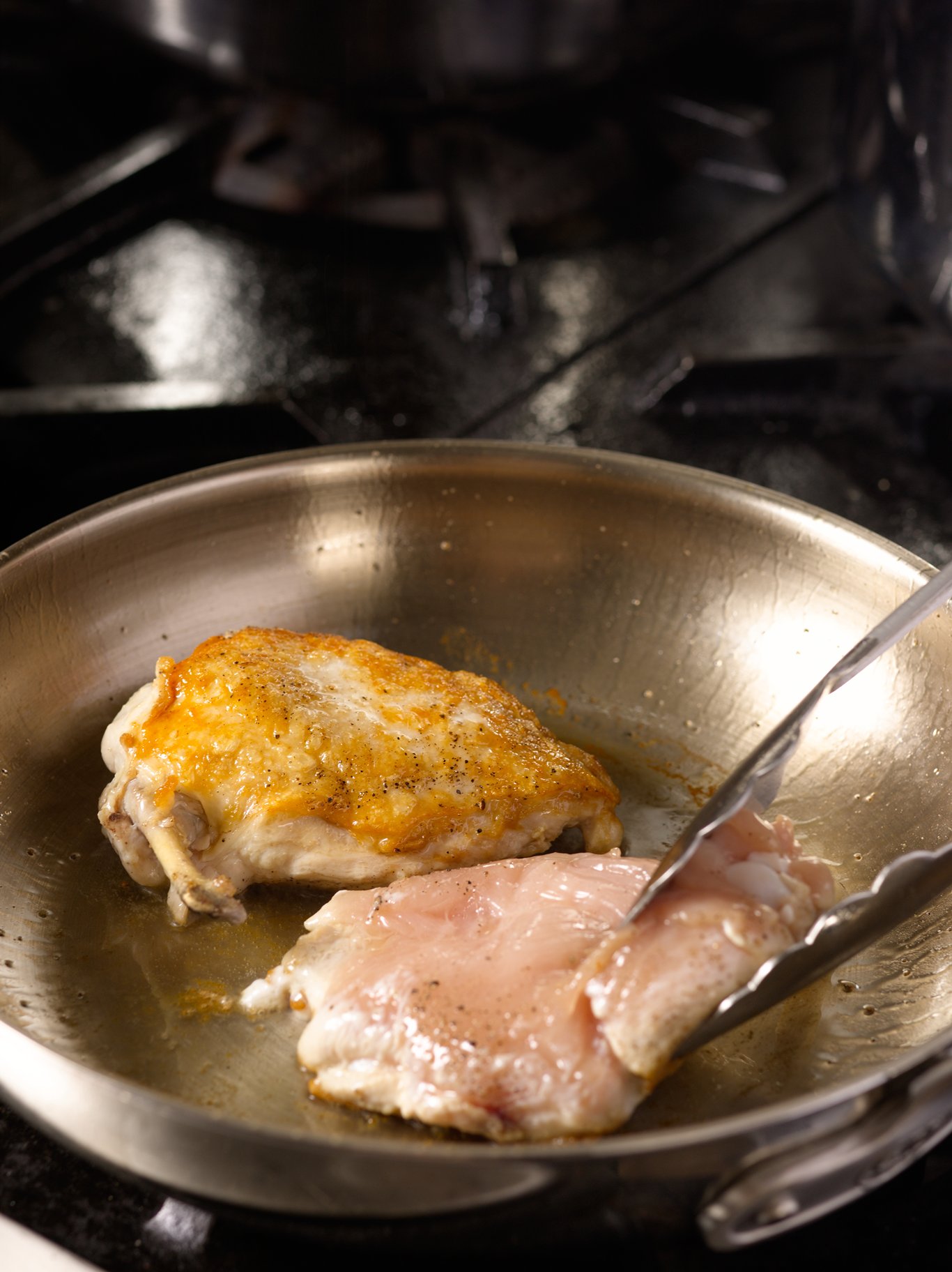 Turning chicken in a saute pan