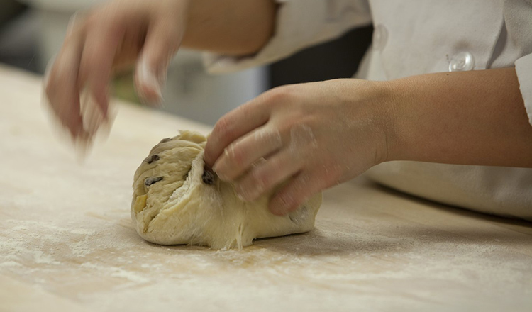 Chef Hans Welker teaches bread making techniques to students.