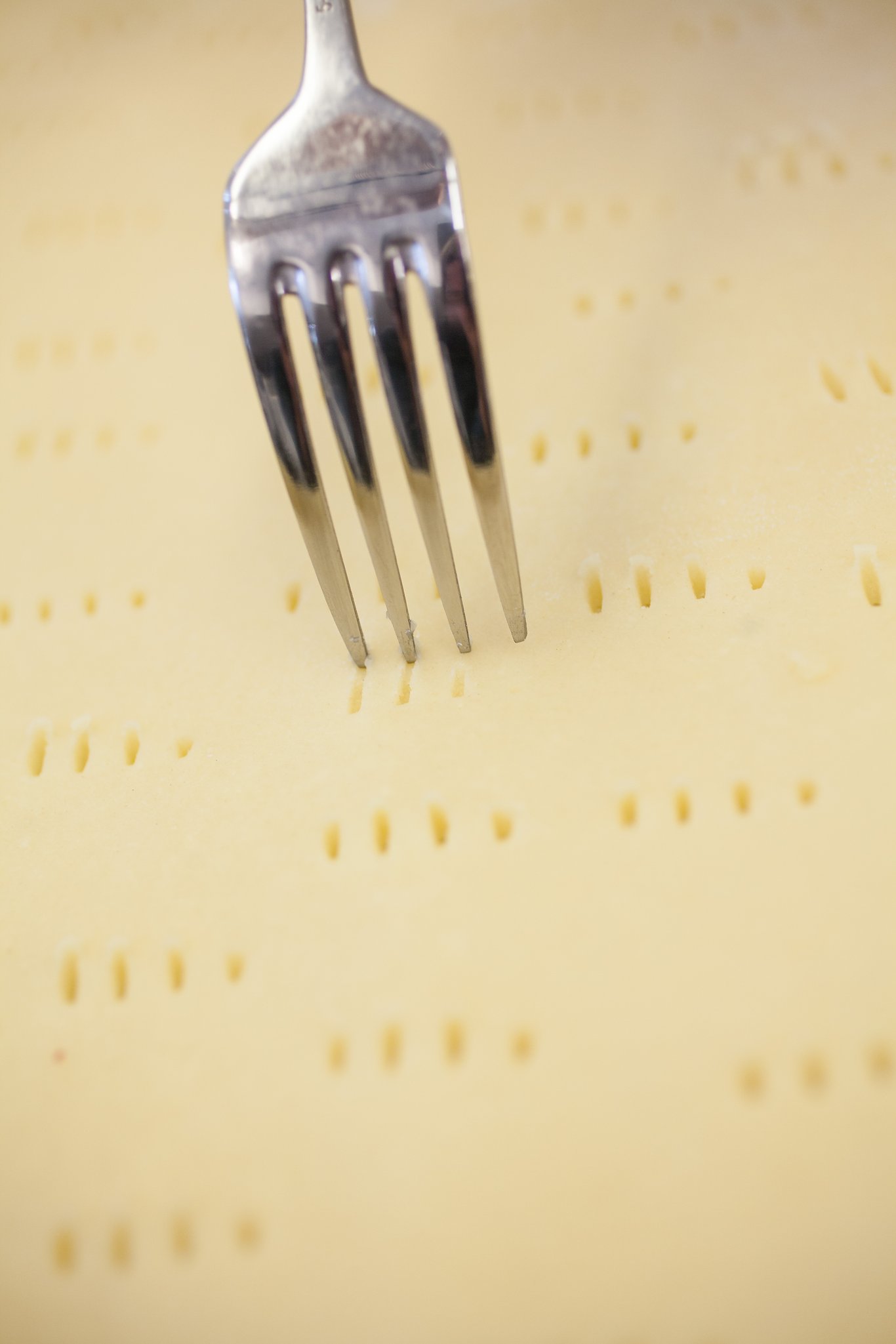 Docking pie dough with a fork