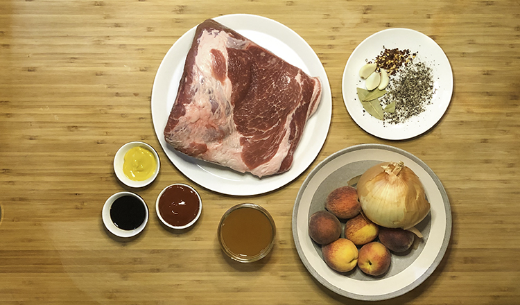 Ingredients for pulled pork: pork butt, garlic, spices, onions, peaches, vinegar, ketchup, soy sauce, and mustard