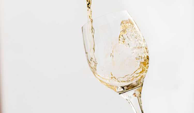 White wine pouring into glass