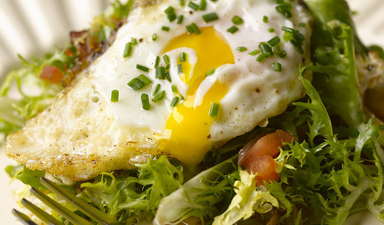 Frisee Salad with Olive Oil Poached Egg and Lardons.