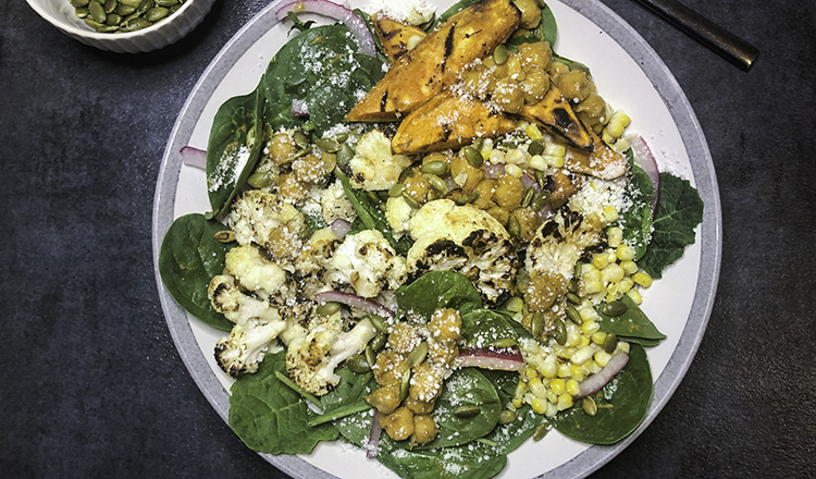 Grilled vegetables and adobo chickpeas over spinach and kale