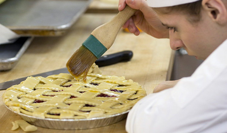 Applying eg wash to pie dough