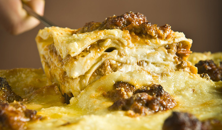 Traditional Lasagna alla Bolognese: layers of cooked pasta with bechamel and meat ragu.