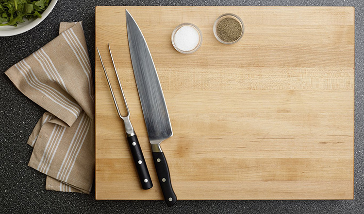 cutting board with knife and carving fork