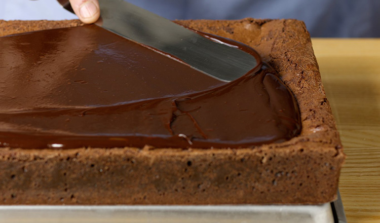 Spreading ganache on bar cookies