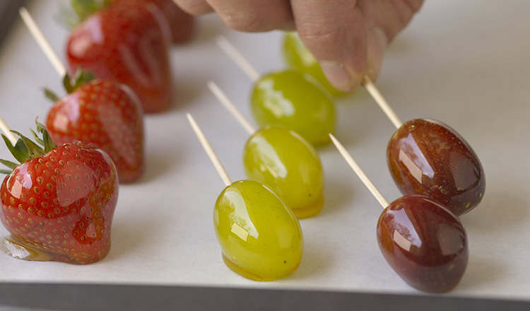 Dipping fresh fruit in sugar