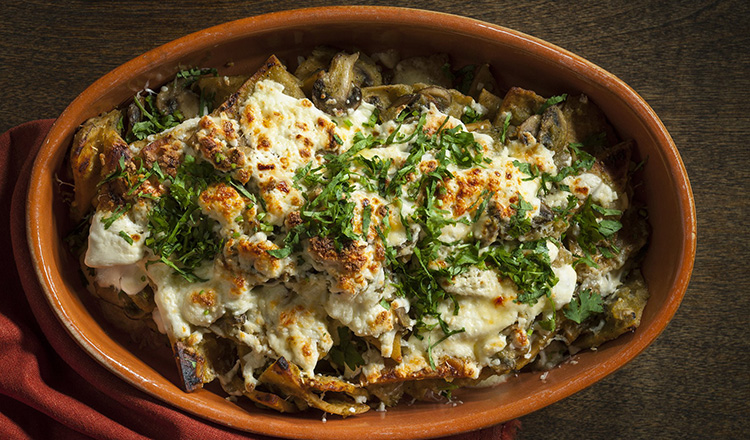 Tortilla, mushroom in a chili sauce smothered in a queso fresco and a queso manchego and baked