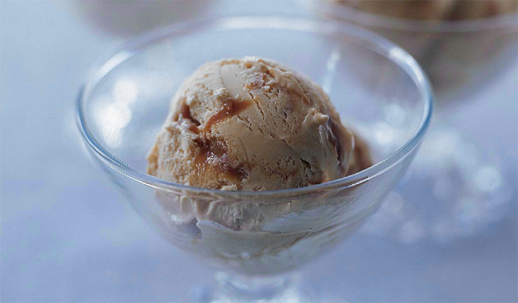Caramel swirl ice cream in a glass bowl