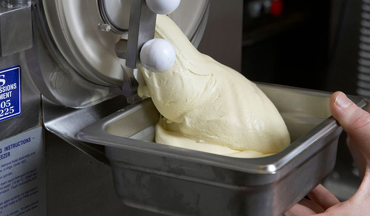 Finished ice cream being extracted from ice cream machine