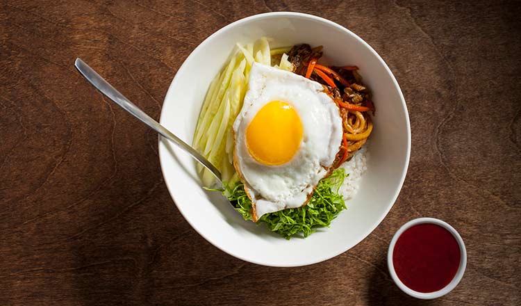 Fried egg over rice and vegetables