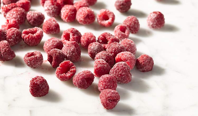 Individually quick frozen raspberries on marble