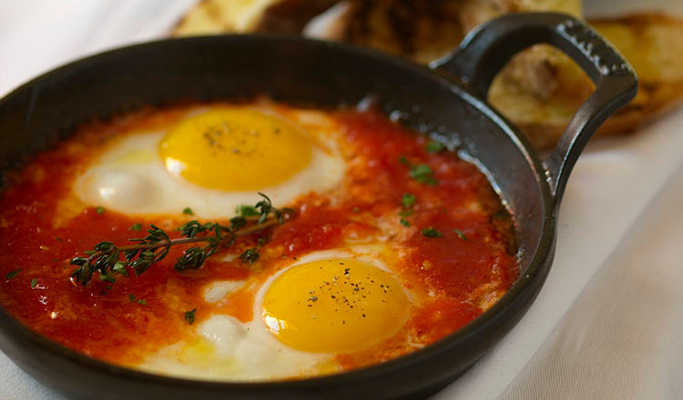 Eggs poached in tomato sauce in a cast-iron pan