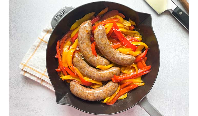 Sausage with Sweet and Sour Peppers in a cast-iron skillet