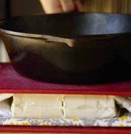 Pressing tofu between cutting boards