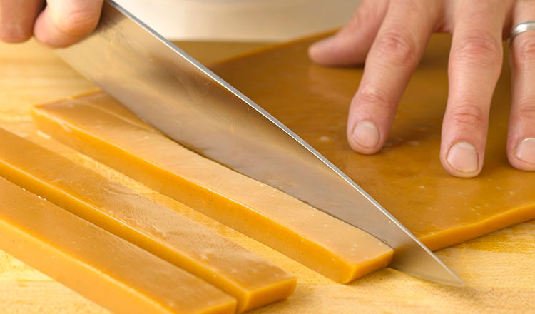 Cutting caramel slab into pieces