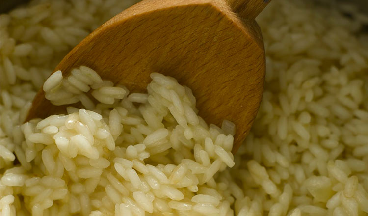 Rice stirred with a wooden spoon