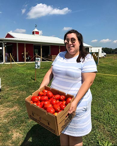 Woman carrying tomatoes