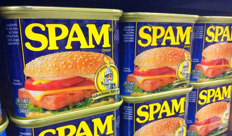 Cans of spam stacked on a shelf