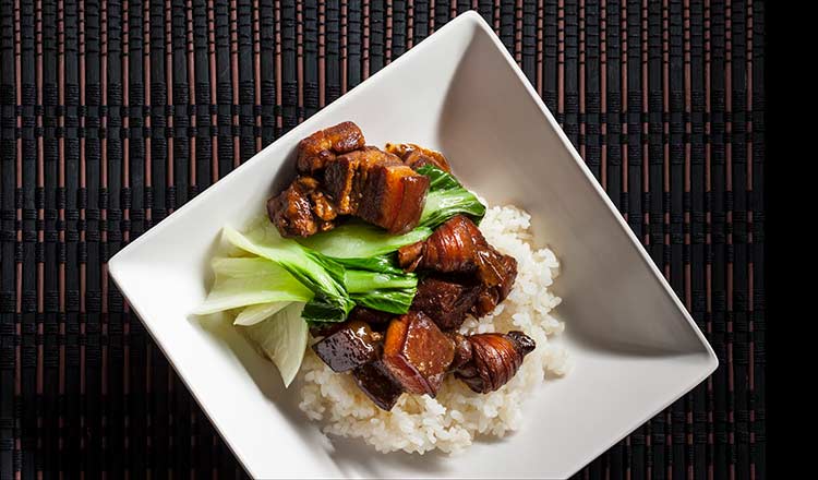 Pork belly in bowl with rice and bok choy