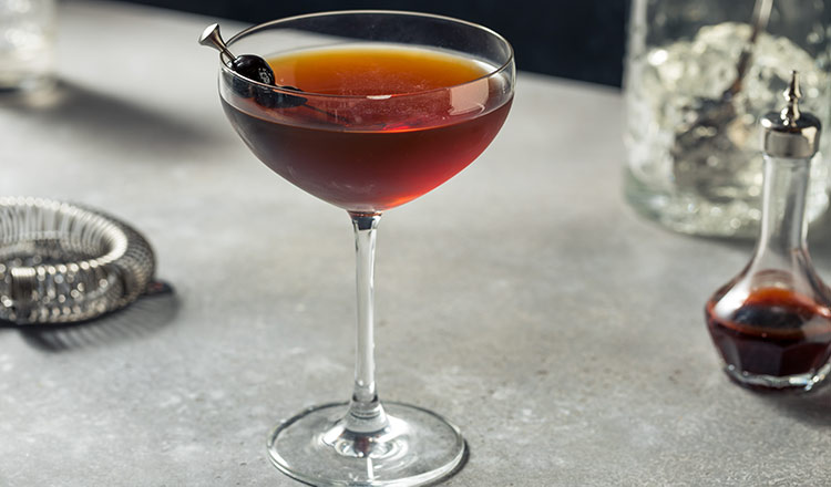 Manhattan in a cocktail glass with cherries