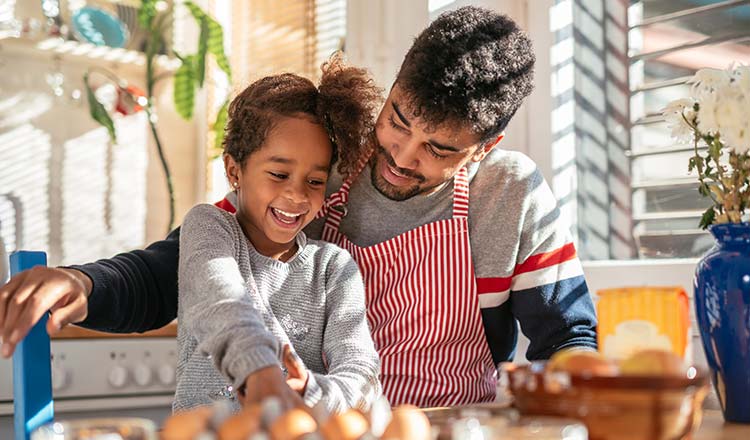 Girl baking with dad