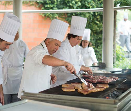 Chef grilling in outdoor kitchen