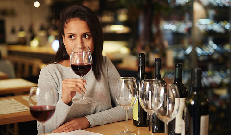 Woman tasting red wine