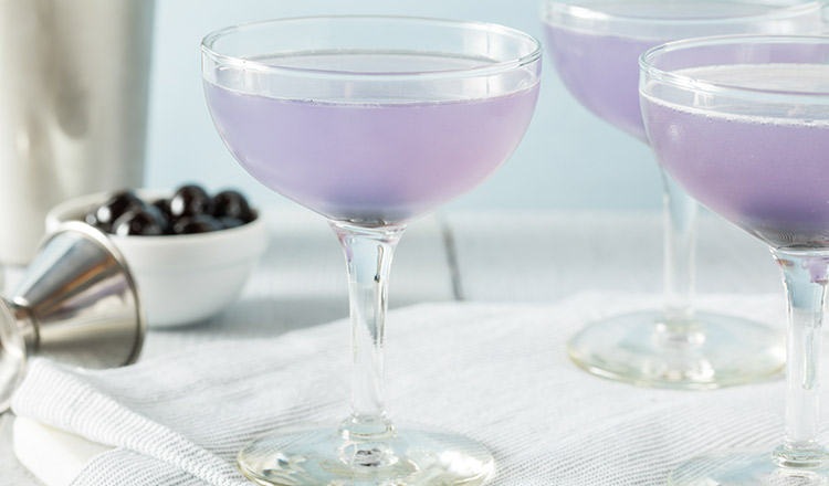 Violet-colored cocktail in a coupe glass